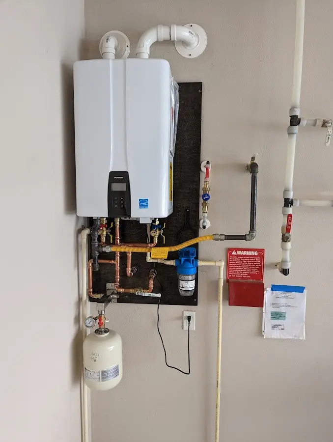 Professional plumber installing copper piping in a North Muskegon home